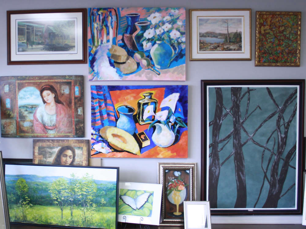 framed artwork from local Quinte artists hanging on the wall in a custom framing shop